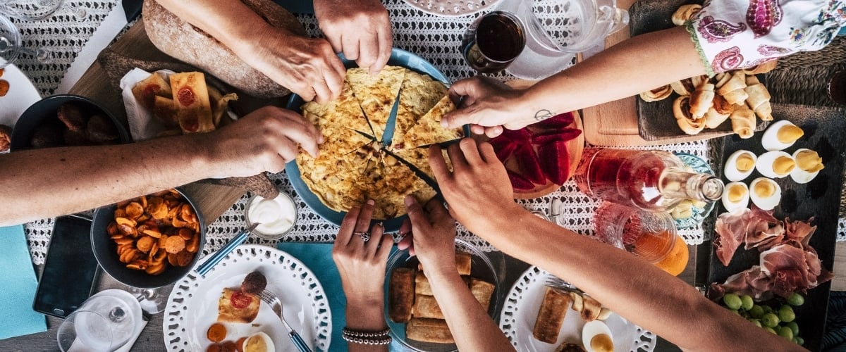 Friends sharing food at a restaurant table