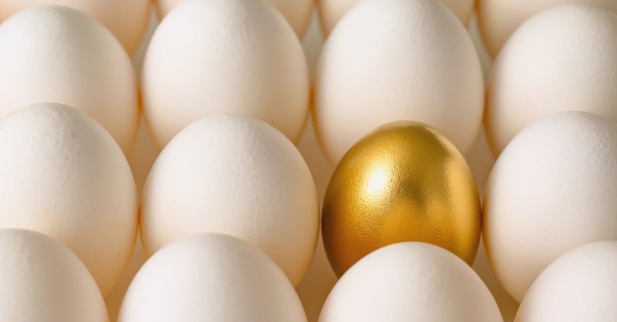 Gold egg standing out from white eggs, representing food inflation