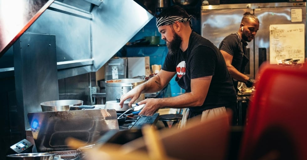 Kitchen staff cooking during service — tracking food usage and inventory in real time.