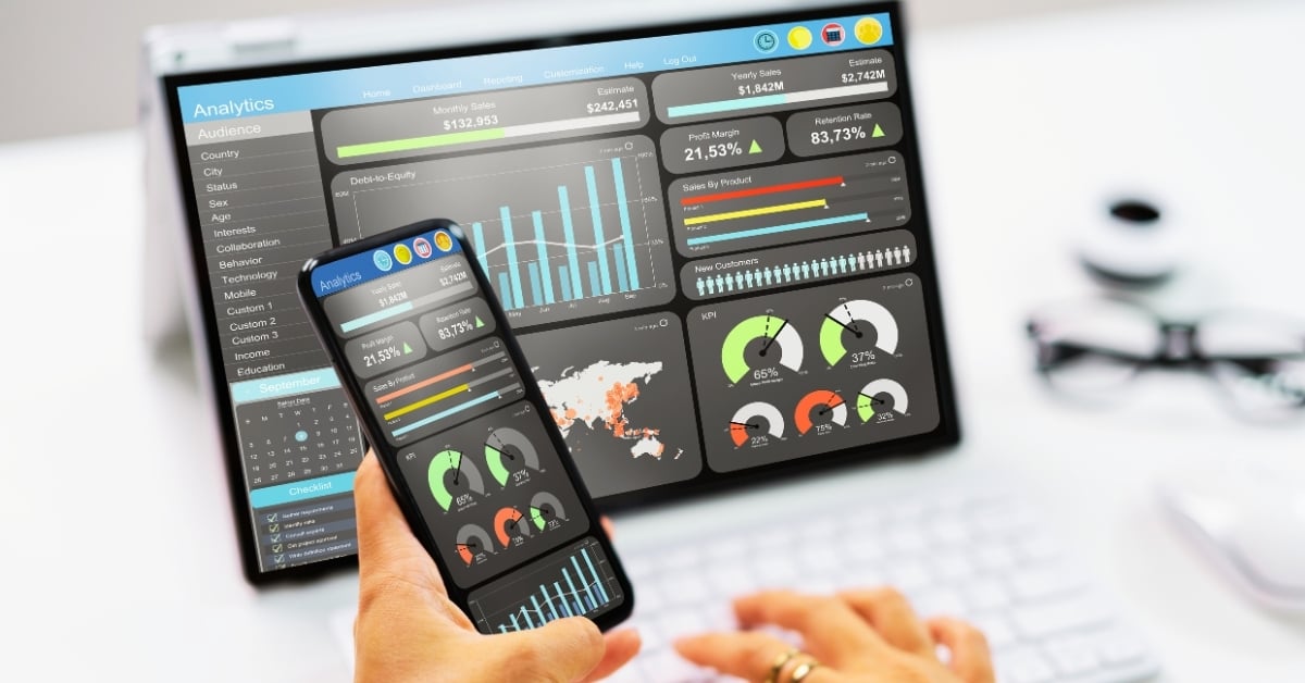Restaurant manager reviewing performance dashboards on a laptop and smartphone showing KPIs, sales metrics, and profit margin analytics — illustrating data-driven restaurant operations management.