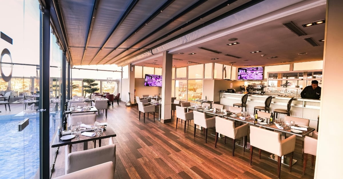 Modern lounge-style restaurant interior with bar seating