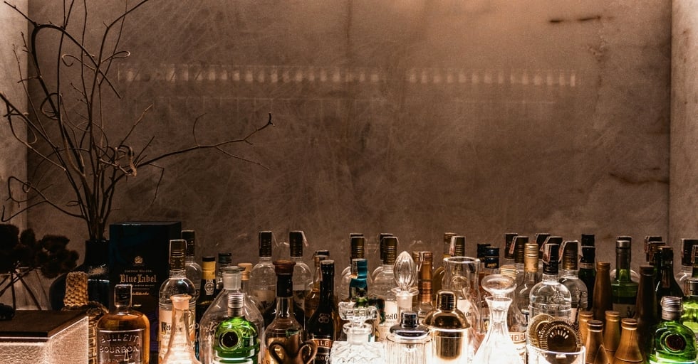 Liquor shelves stocked and organized, showing the role of successful bar management in maintaining inventory control.