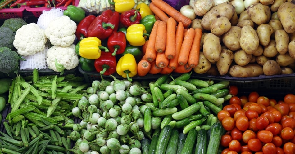 Assorted fresh vegetables including carrots, peppers, cucumbers, and tomatoes.