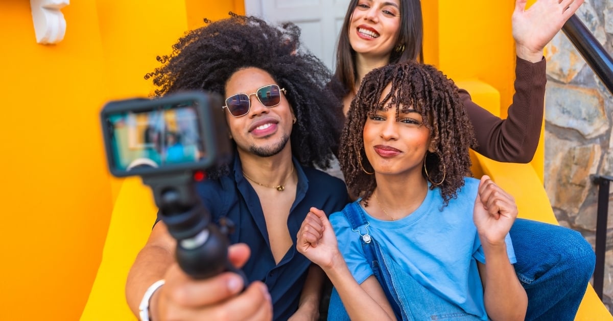 People filming social media content on a phone, illustrating how restaurants benefit from user-generated and influencer-style marketing.
