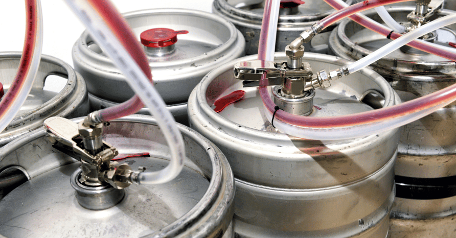 Draft beer kegs connected to clean tap lines in bar cooler