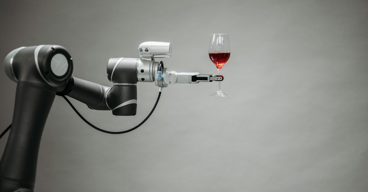 A robotic arm holding a glass of red wine, symbolizing restaurant technology, automation, and the future of dining.