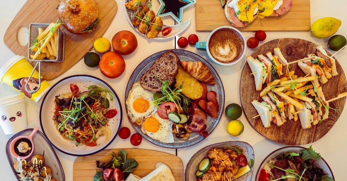 Full restaurant menu spread featuring burgers, sandwiches, breakfast plates, fries, salads, and plated entrées — illustrating menu variety for menu engineering and food cost control.