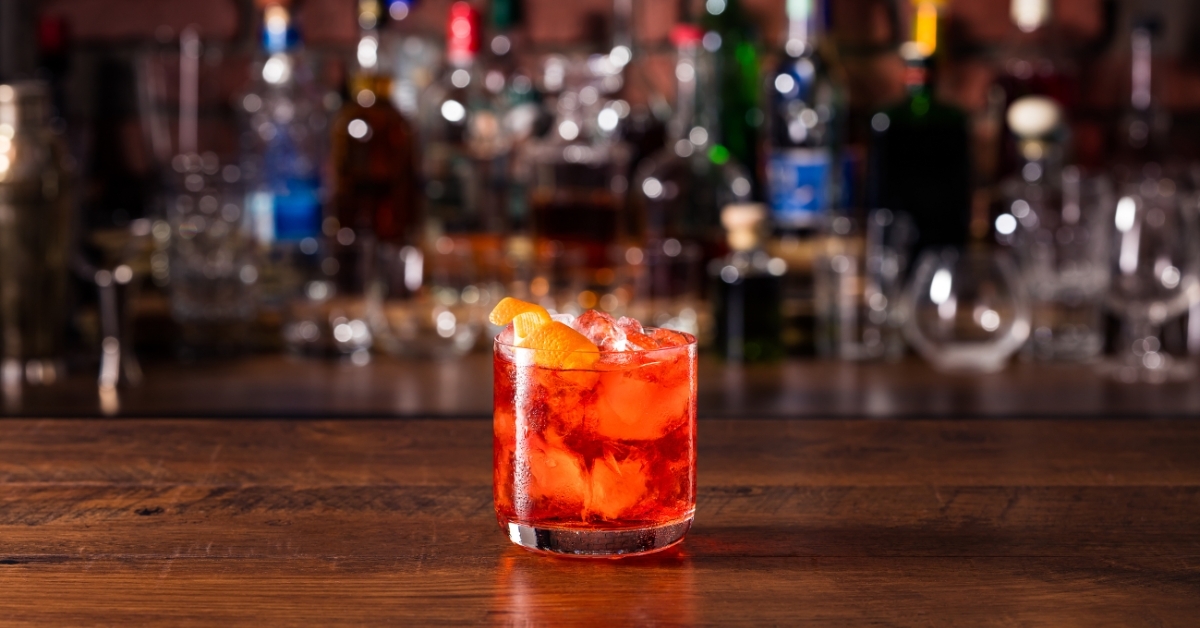 Close-up of a Negroni cocktail with orange peel garnish