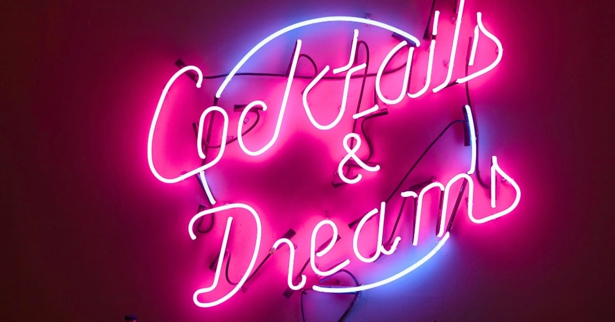 Neon sign reading “Cocktails & Dreams”