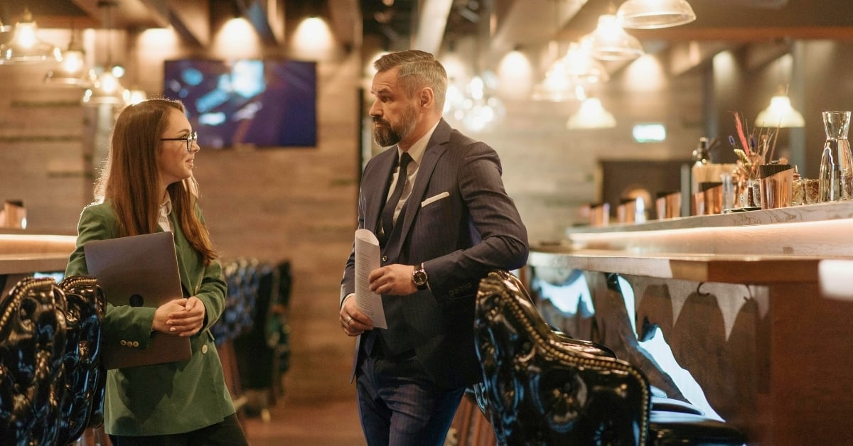 Consultant and bar owner discussing strategies for successful bar management to improve operations and profitability.